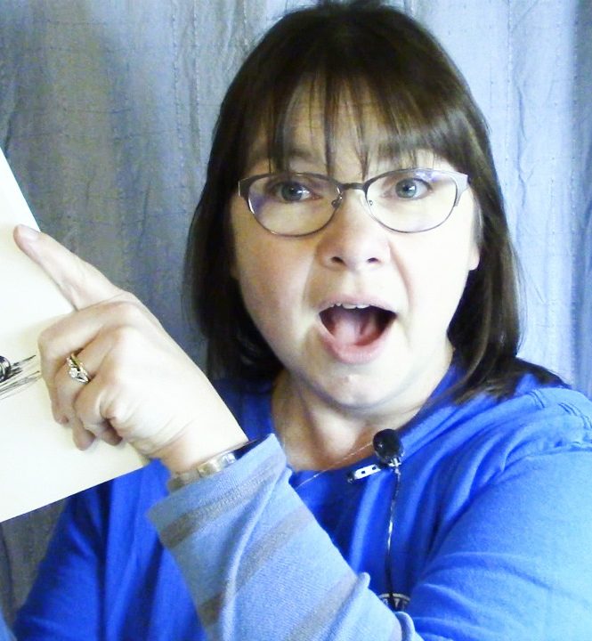 Woman in blue holding sketchbook